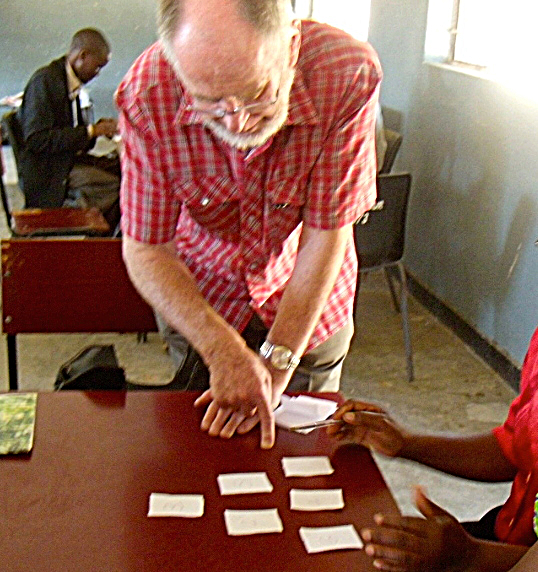 Image for Figure 7: Here I talk with a small group of teachers about the triangle puzzle