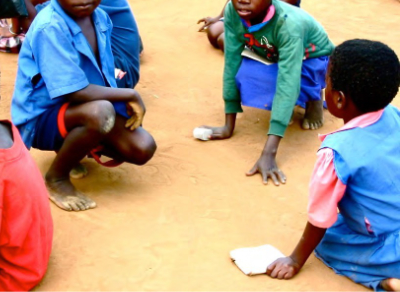 Photo of pupils writing in the dust